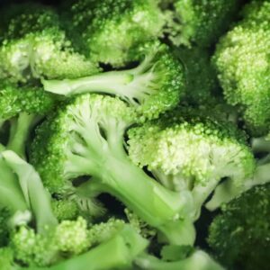 Bright green broccoli florets boiling in a pot for a fresh, healthy meal.