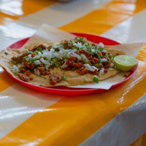 Close-up of a traditional Tlayuda with lime served at a table in Mexico City.