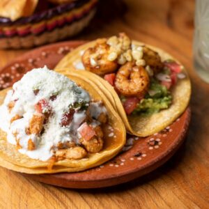 Close-up of flavorful shrimp and chicken tacos with guacamole, served in a San Francisco restaurant.