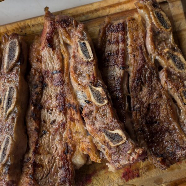 Delicious traditional Argentine asado, grilled steaks with bread, perfect for a classic meal.