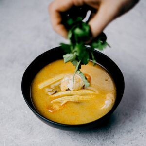 Savor this flavorful shrimp soup with baby corn and cilantro, perfect for Asian cuisine lovers.