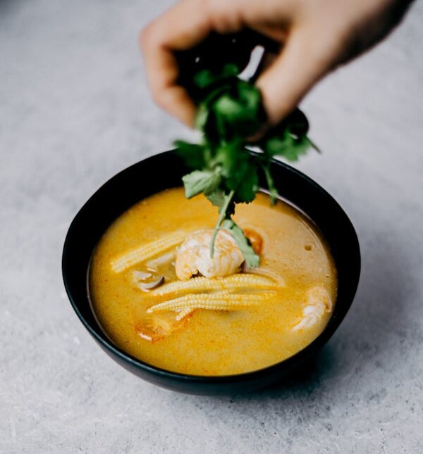 Savor this flavorful shrimp soup with baby corn and cilantro, perfect for Asian cuisine lovers.
