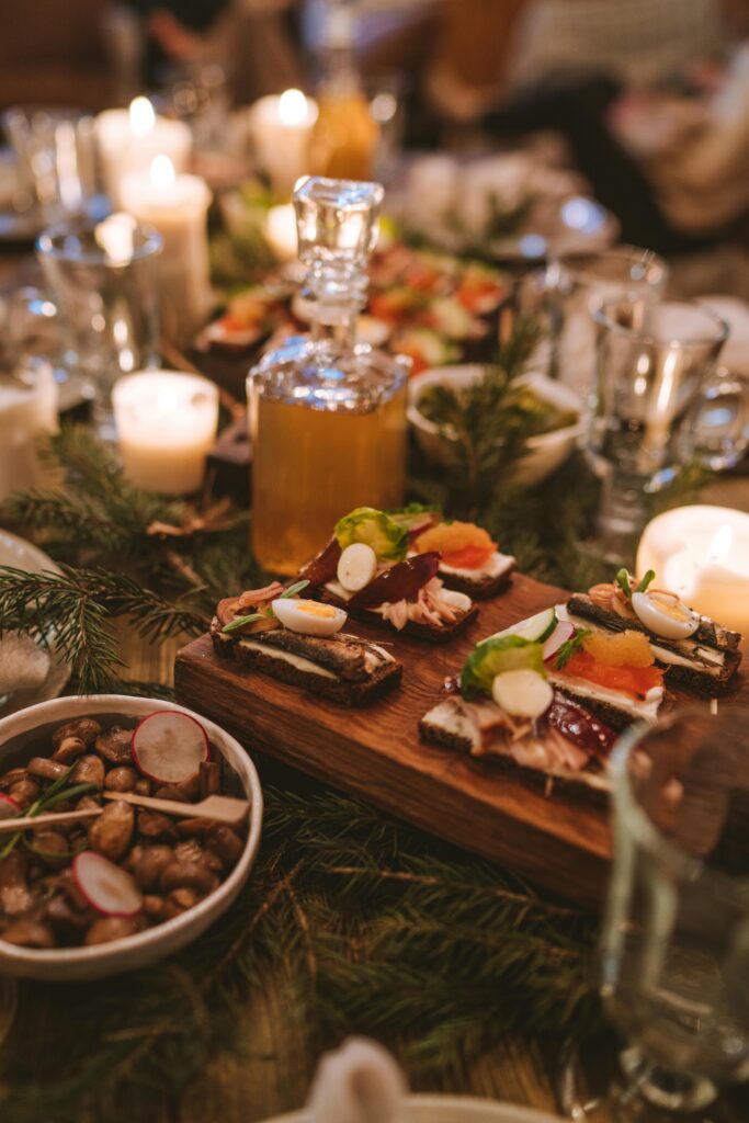 Cozy holiday dinner scene with candles, appetizers, and festive decor.